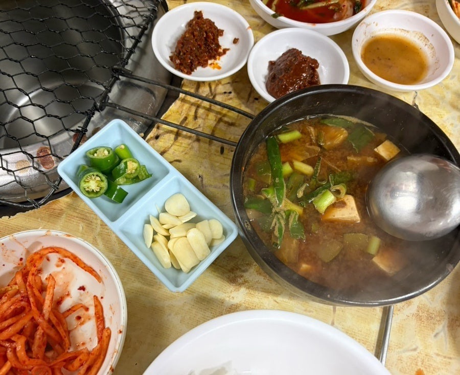 “Doenjang jjigae stew with banchan side dishes and grill at Hoseong”